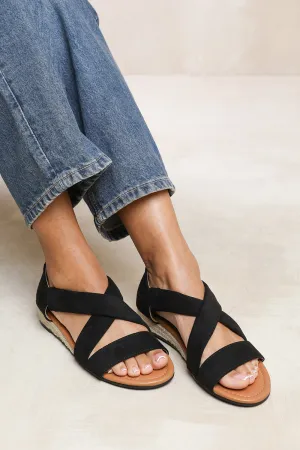 HUMMINGBIRD LOW WEDGE SHOES WITH CROSS OVER STRAP IN BLACK SUEDE