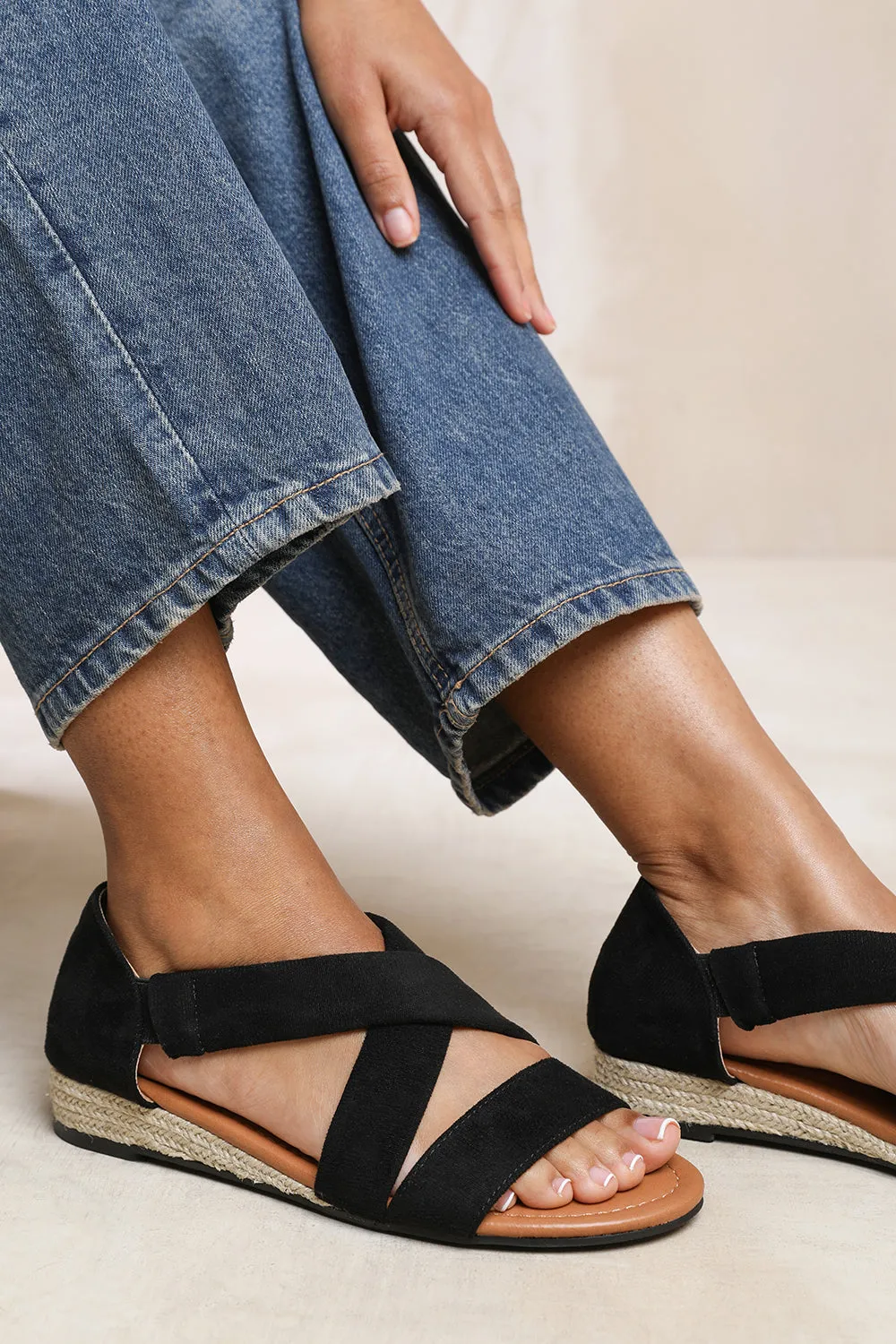 HUMMINGBIRD LOW WEDGE SHOES WITH CROSS OVER STRAP IN BLACK SUEDE